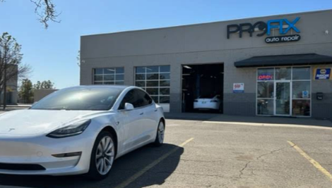 Exterior Of PROFIX Auto Repair Shop With White Tesla Parked Outside | PROFIX Auto Repair and Leon's PROFIX Auto Repair