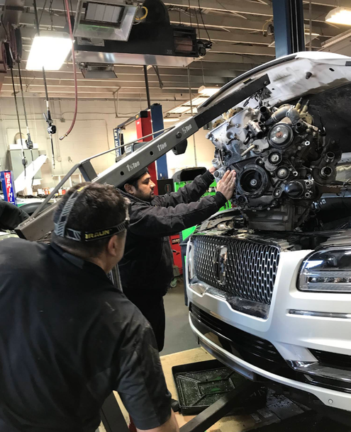 Technicians Installing Engine Into Vehicle Inside Auto Repair Shop | PROFIX Auto Repair and Leon's PROFIX Auto Repair