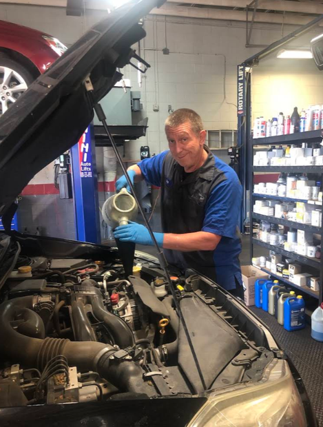 Mechanic Pouring Fresh Oil Into Vehicle Engine Bay During Service | PROFIX Auto Repair and Leon's PROFIX Auto Repair