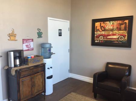 Customer Waiting Area With Chair, Water Dispenser, And Wall Art | PROFIX Auto Repair and Leon's PROFIX Auto Repair
