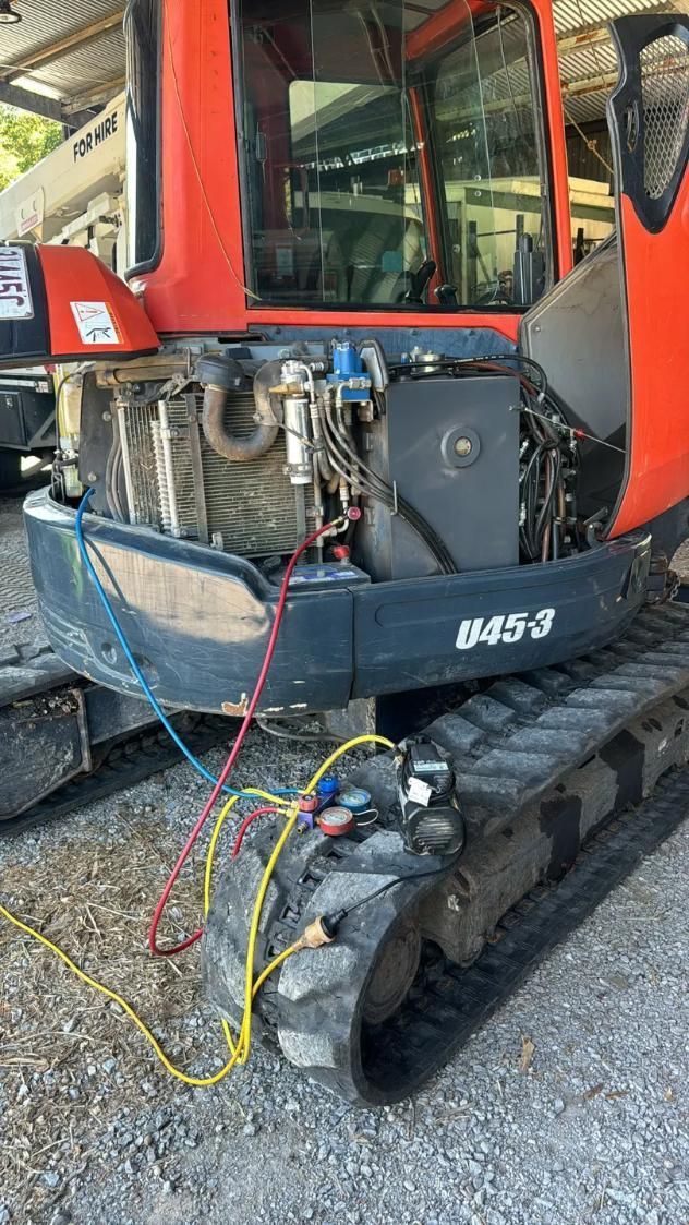A Red and Black Excavator is Sitting on Top of a Gravel Road — Activate Auto Electrics & Air Conditioning In Caloundra, QLD
