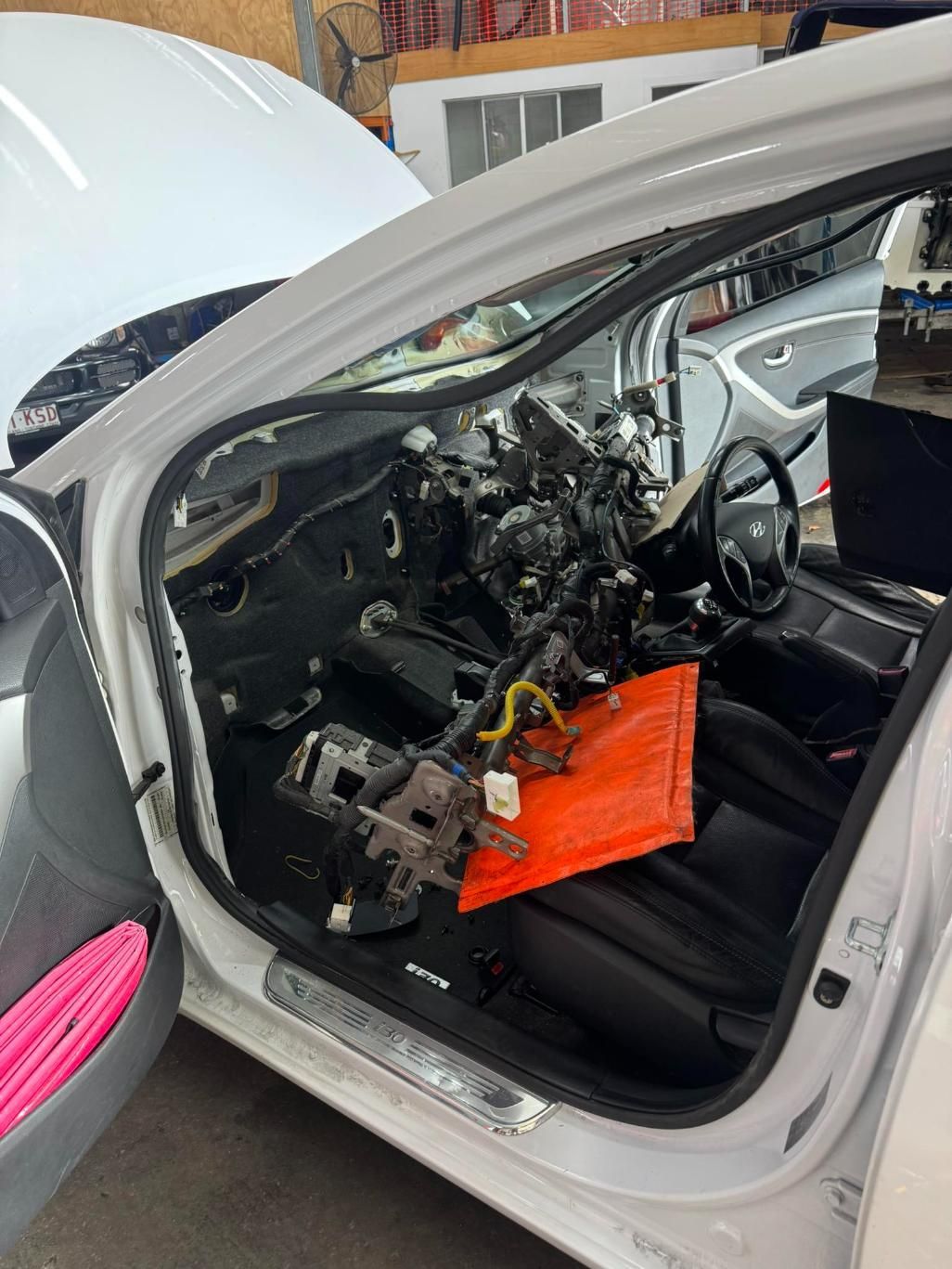 The Inside of a White Car is Being Worked on in a Garage — Activate Auto Electrics & Air Conditioning In Caloundra, QLD
