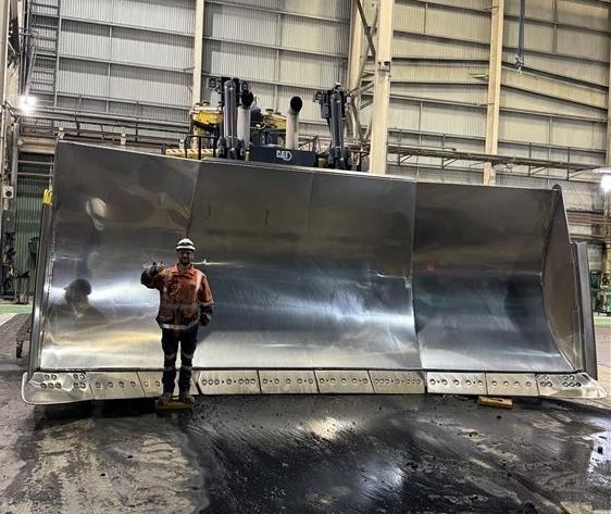Man Standing In Front Of Very Large Earthmoving Machine — Activate Auto Electrics & Air Conditioning In Caloundra, QLD
