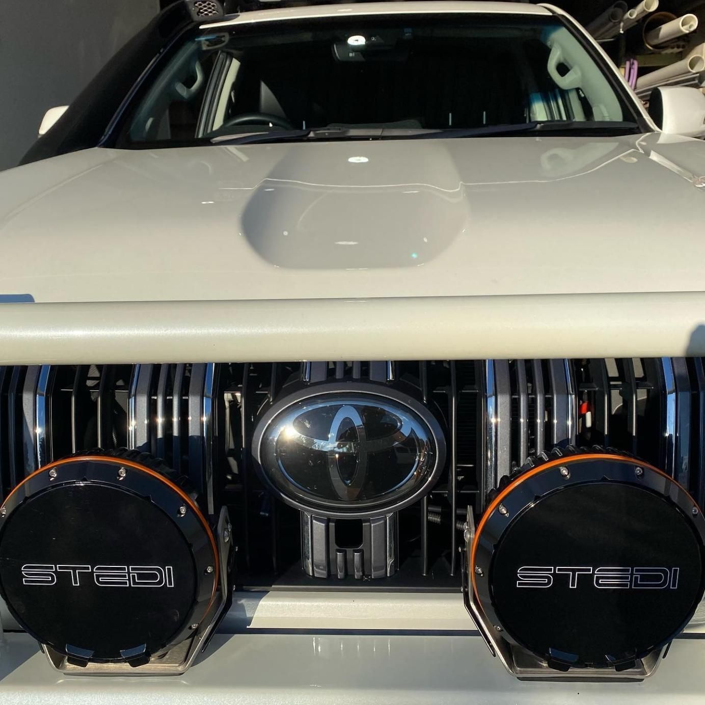 A White Car With a Grille That Says Steel on It — Activate Auto Electrics & Air Conditioning In Caloundra, QLD