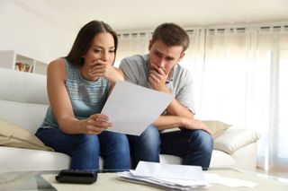 Credit Card Debt — Worried Couple Reading a Document in Aiken, SC