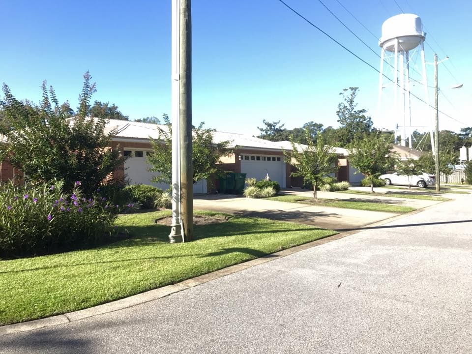 A water tower is in the middle of a residential neighborhood