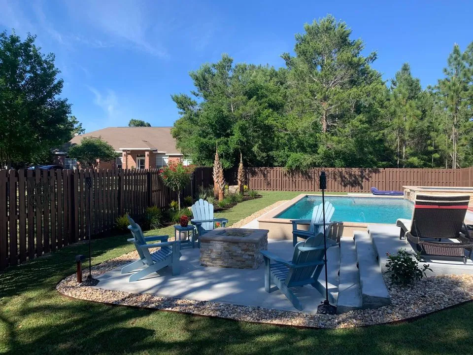 A backyard with a fire pit and a swimming pool.