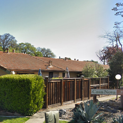 A house with a fence and a sign that says casa nova.