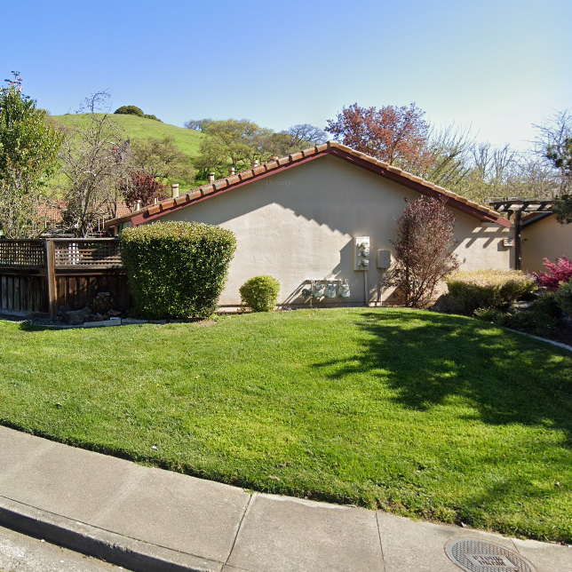 A house with a large lawn in front of it.