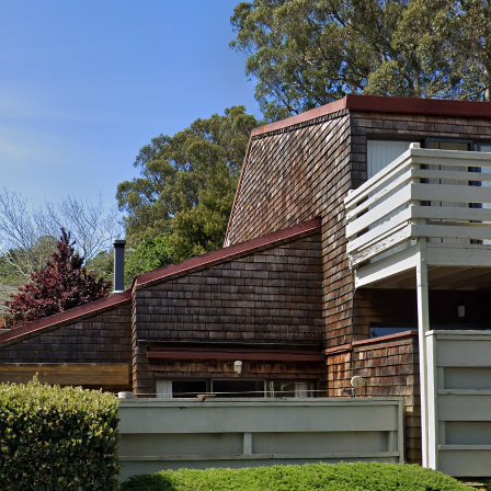 A house with a wooden roof and a balcony.