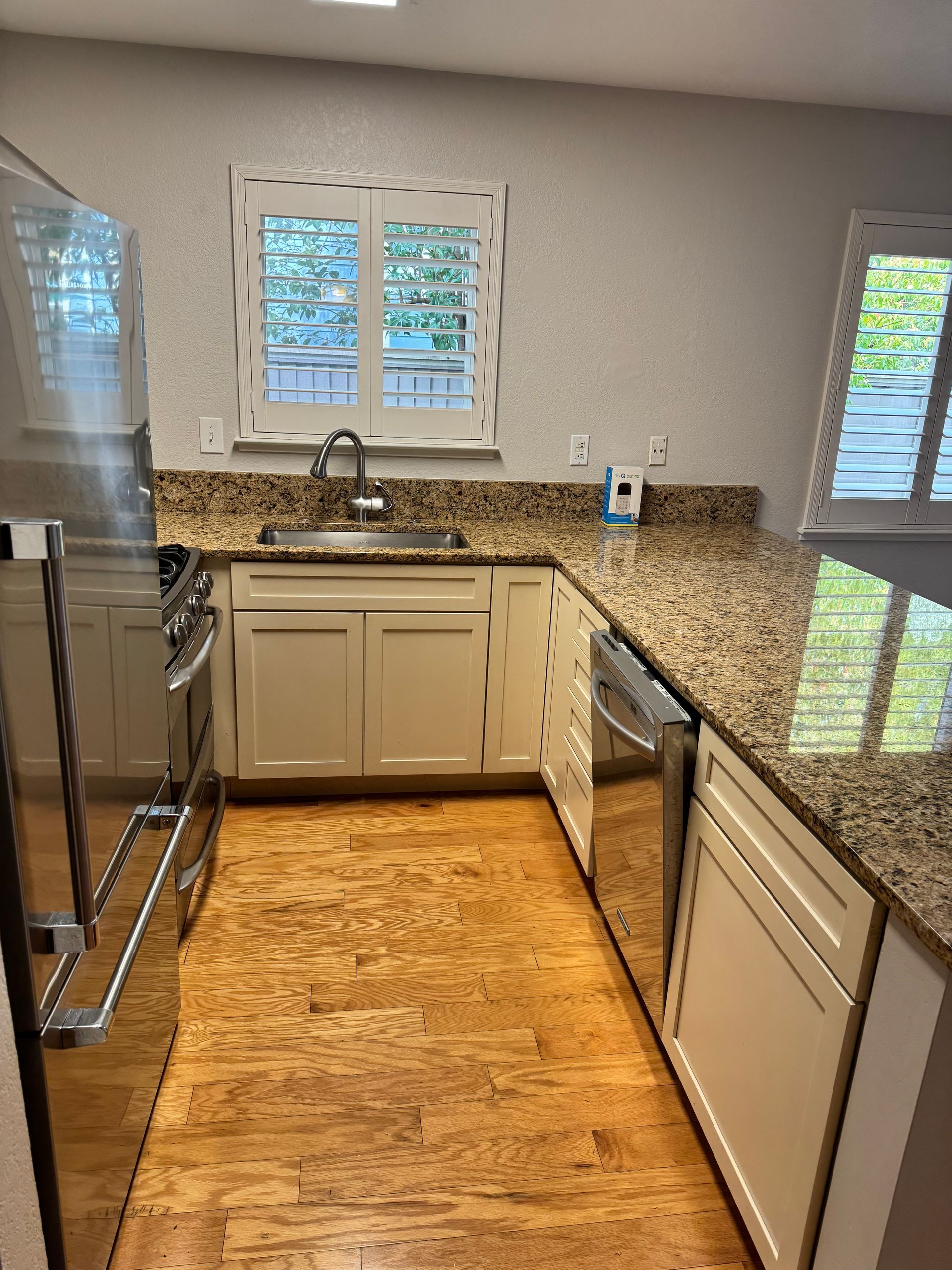 A kitchen with stainless steel appliances and granite counter tops.