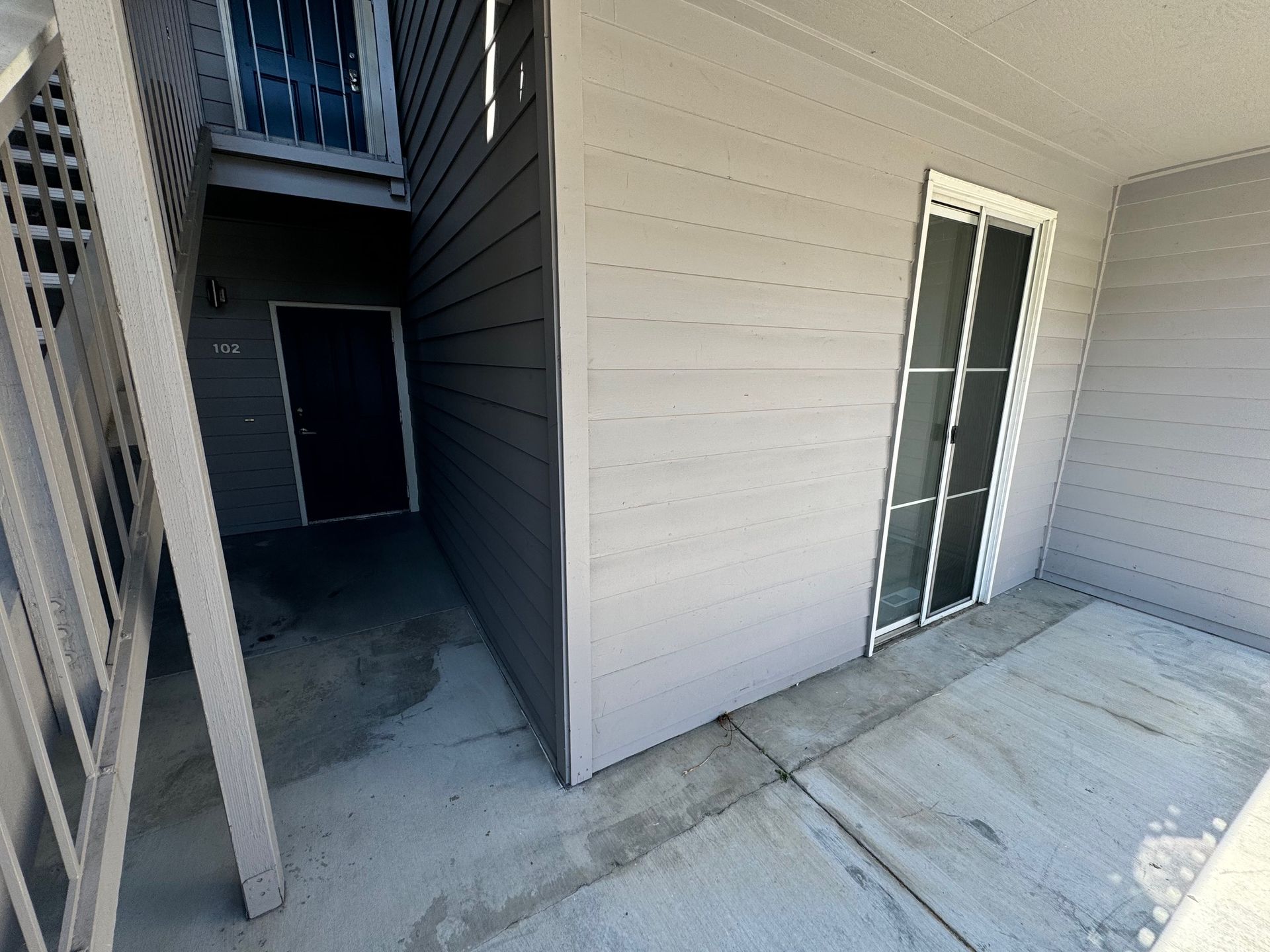 A corner of a building with a sliding glass door