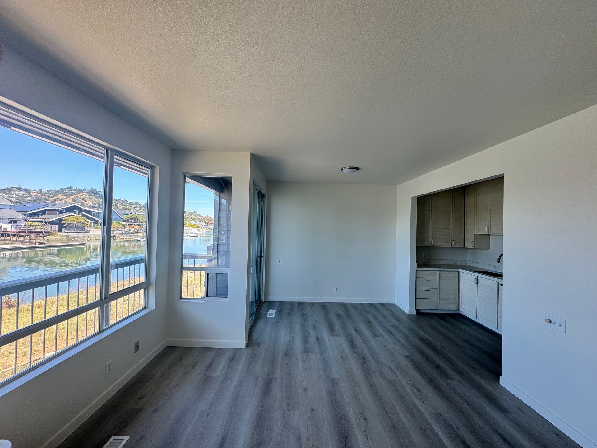 A living room with a lot of windows and a view of a lake