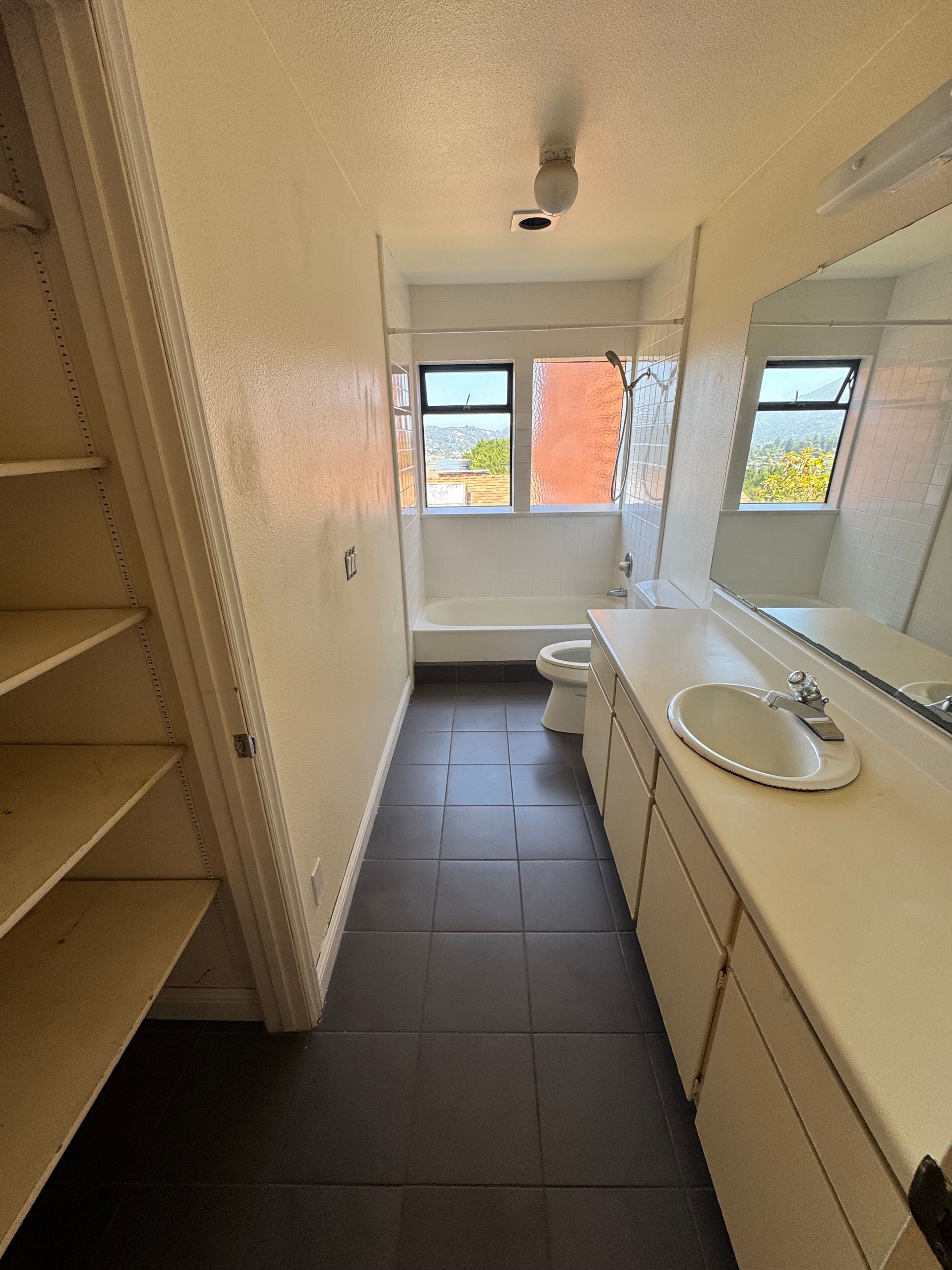 A bathroom with a sink , toilet , and mirror.