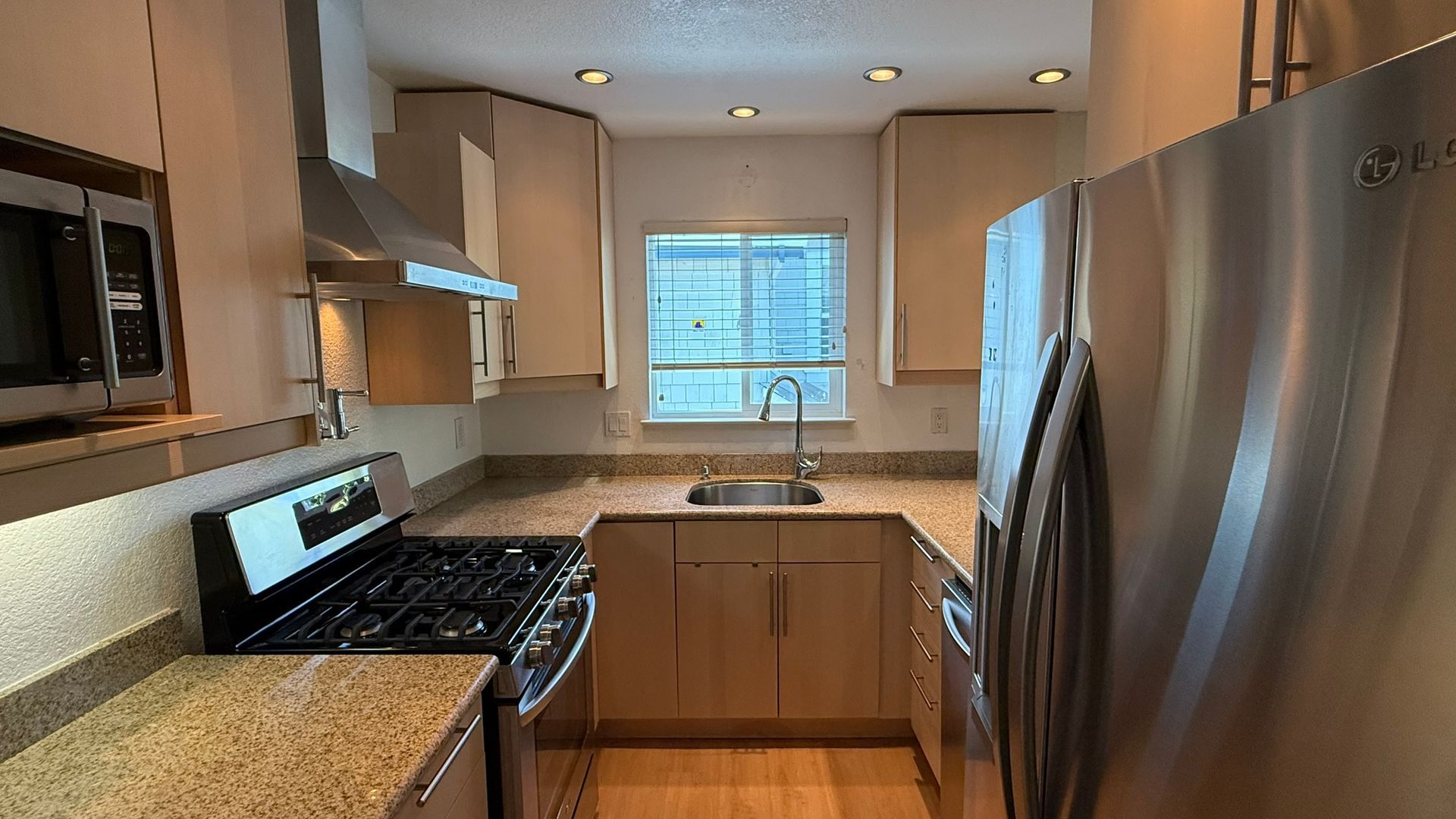 A kitchen with stainless steel appliances and granite counter tops