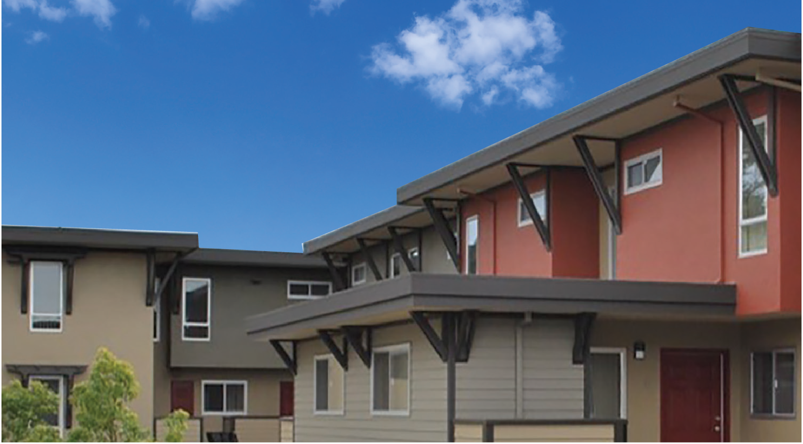 A row of houses with a blue sky in the background