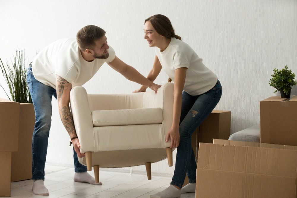 Couple Holding A Chair — Home Renovation in Lennox Head, NSW