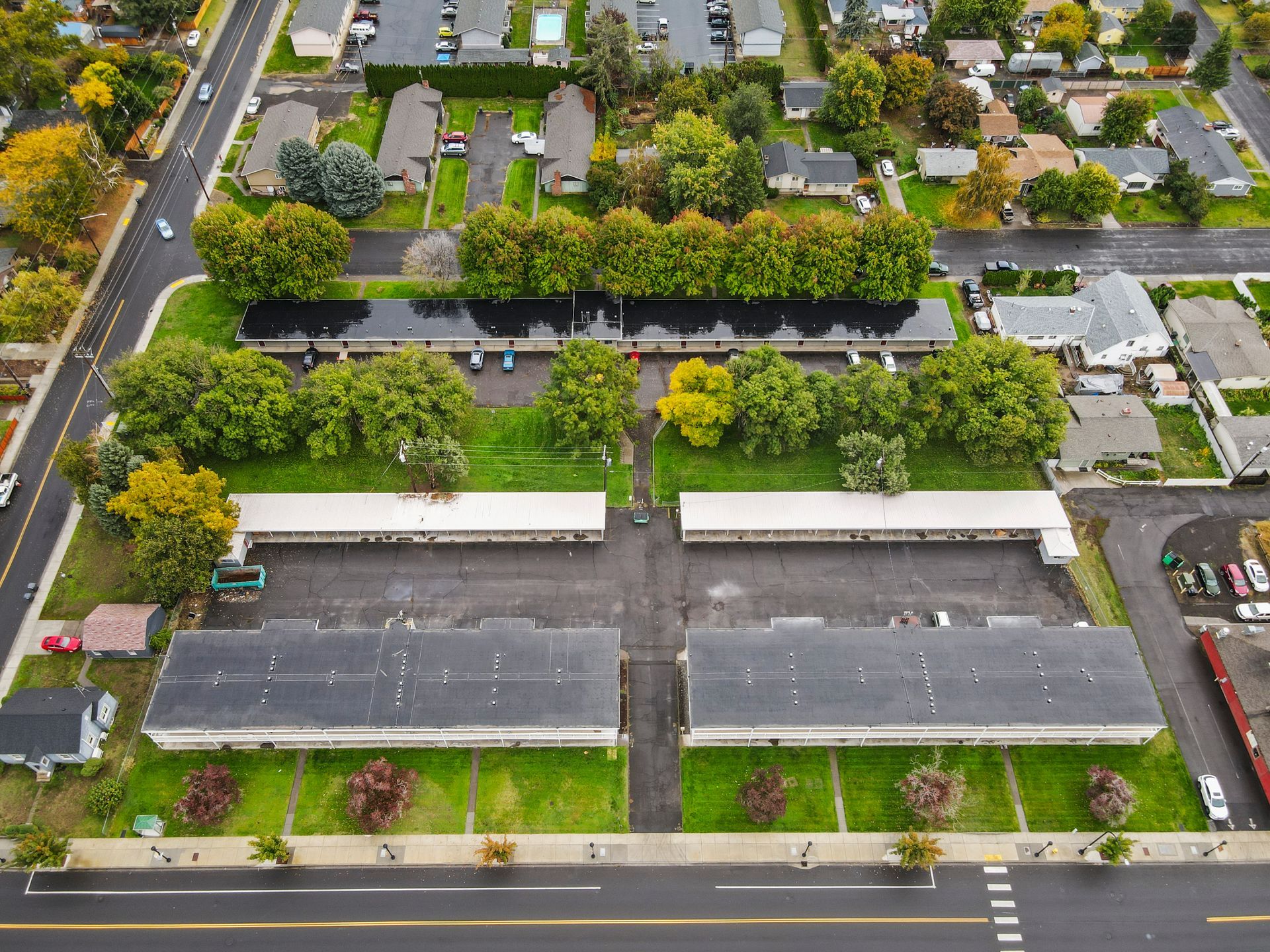 An aerial view of a residential area with lots of trees and buildings.