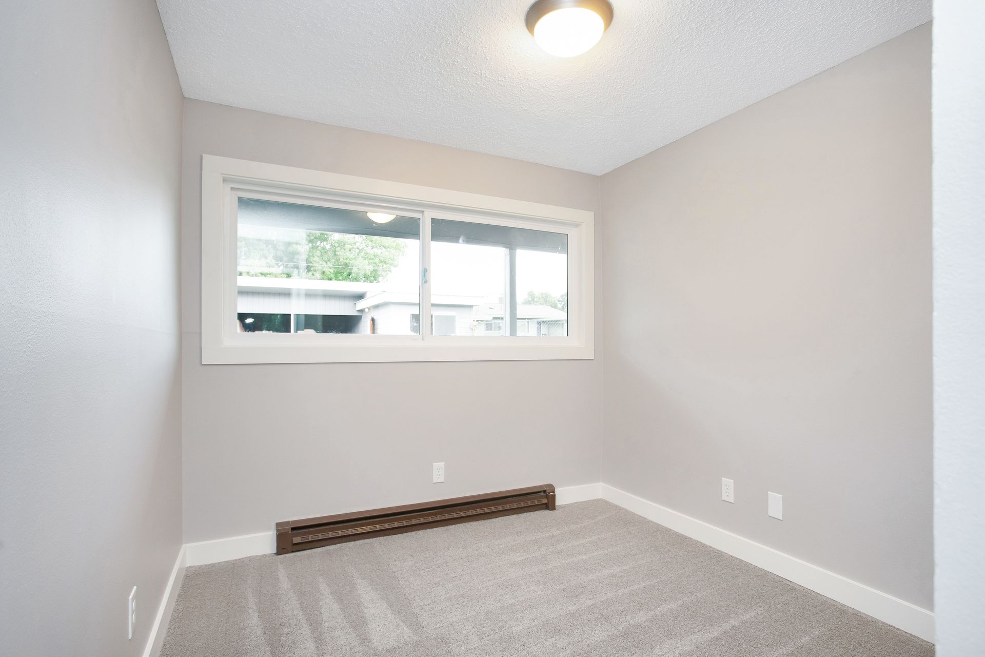 There is a large window in the corner of the room.