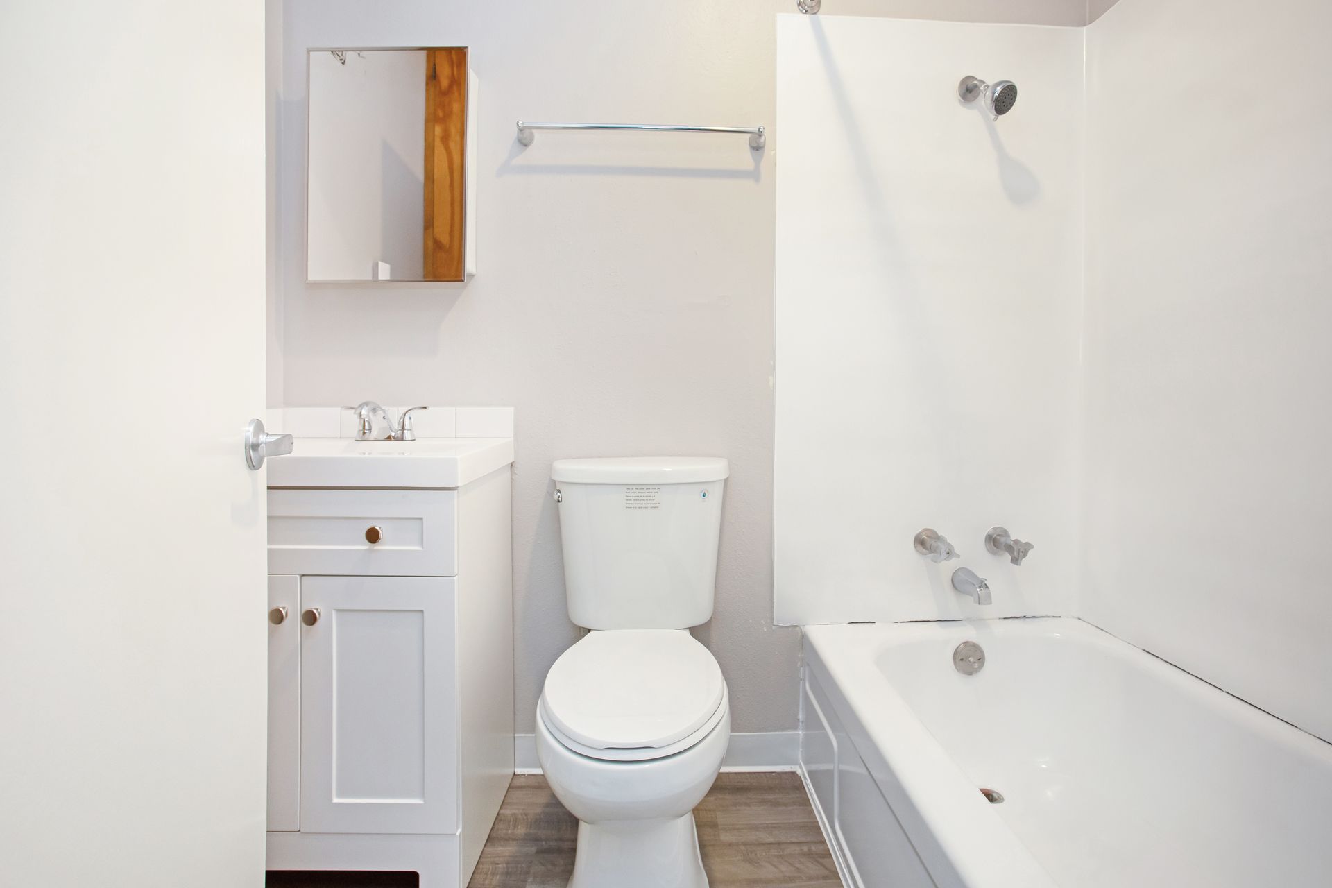 A bathroom with a toilet , sink , and bathtub.
