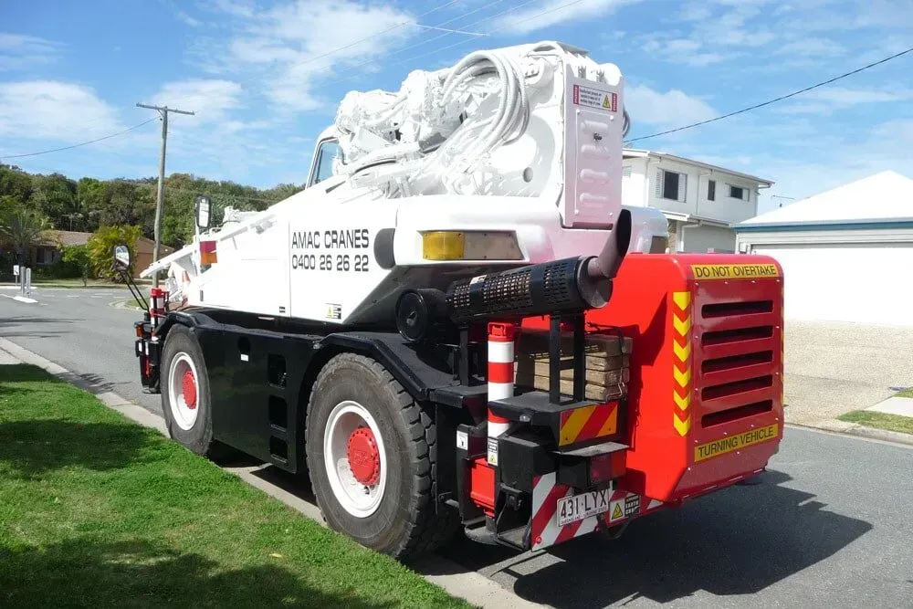 A White and Red Truck Is Parked on The Side of The Road — AMAC Cranes in Coolum Beach, QLD