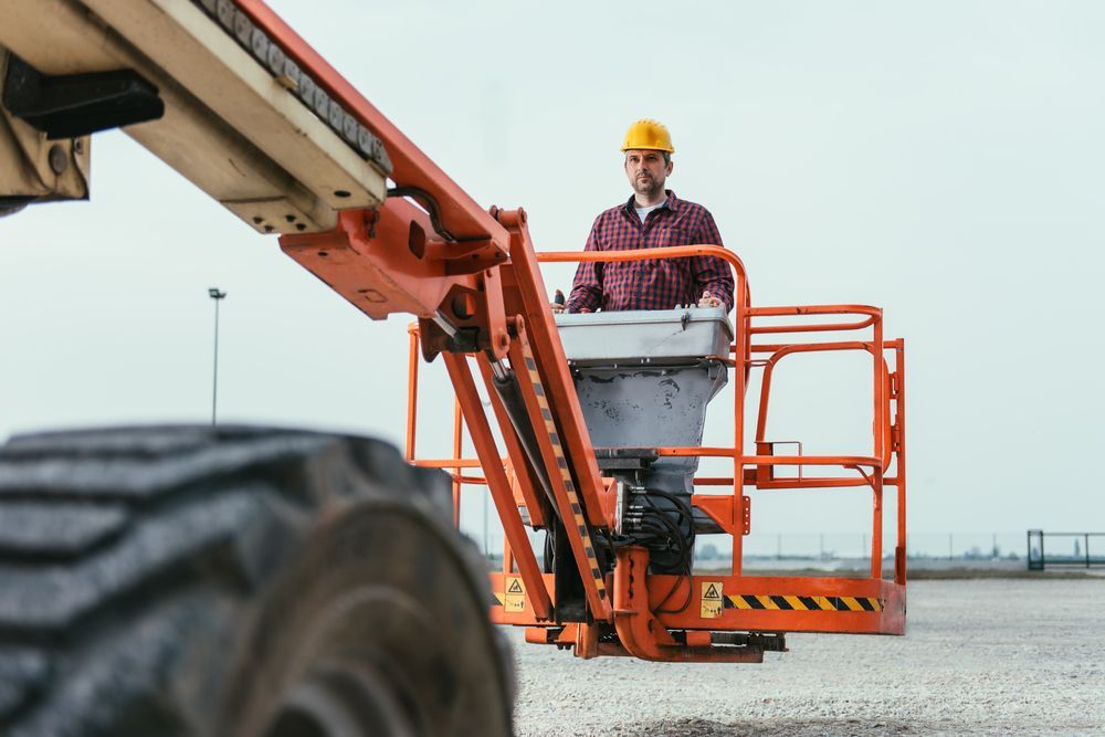 A Man in A Hard Hat Is Standing in A Crane — AMAC Cranes in Maroochydore, QLD