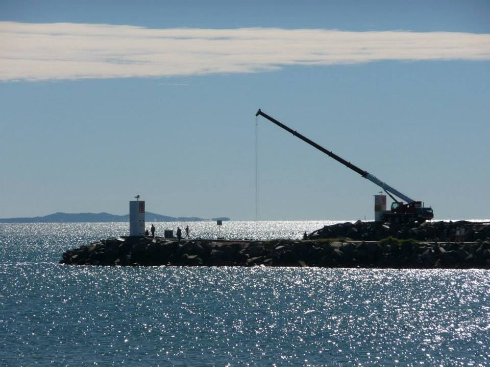 A Construction Crane and A Building Under Construction — AMAC Cranes in Coolum Beach, QLD