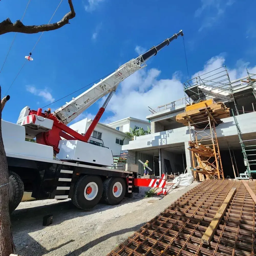 A White Crane Truck Taking Turn On Road — AMAC Cranes in Coolum Beach, QLD