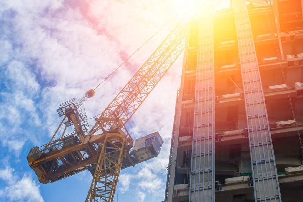 A Construction Crane and A Building Under Construction — AMAC Cranes in Coolum Beach, QLD