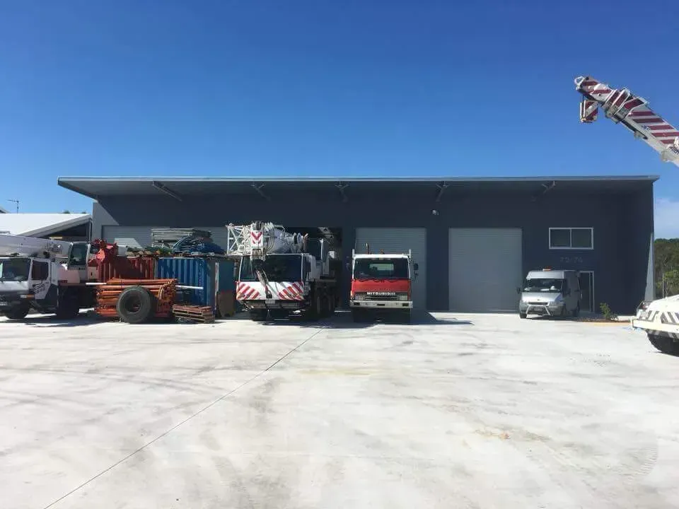 A Row of Trucks Are Parked in Front of A Building — AMAC Cranes in Coolum Beach, QLD