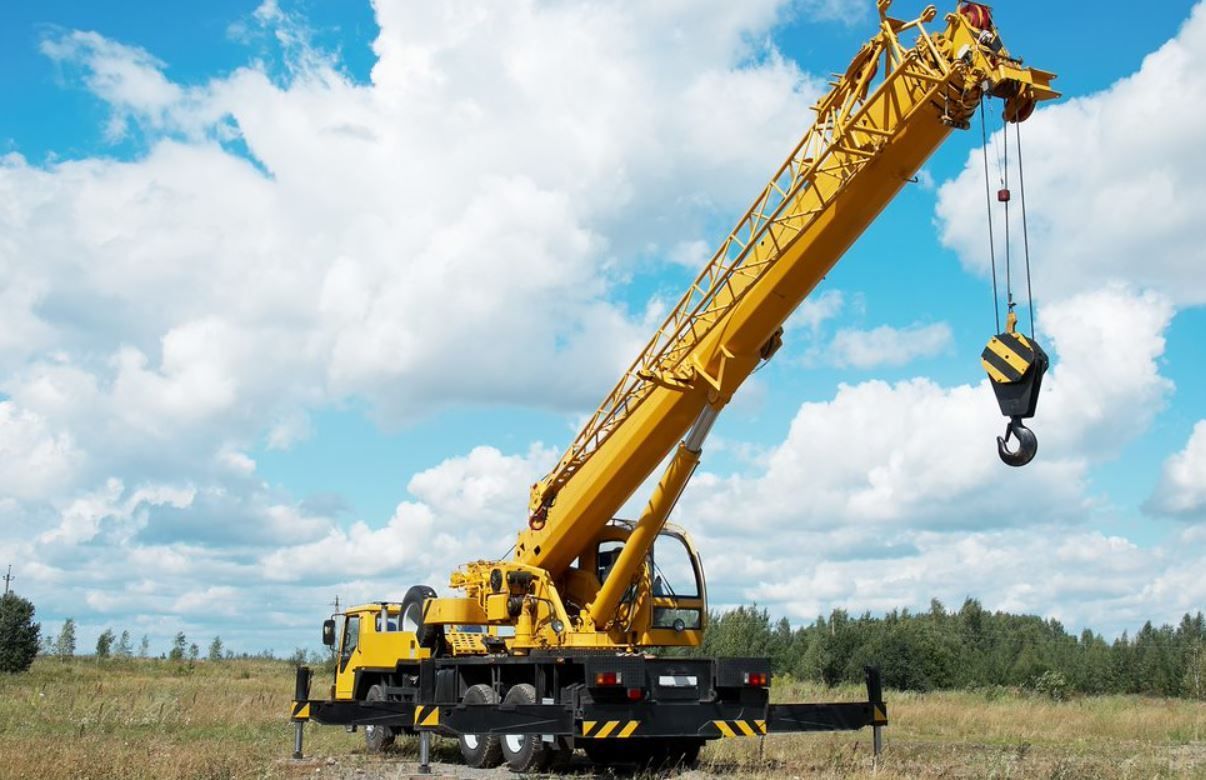 A Large Crane Is Parked in Front of A Building Under Construction — AMAC Cranes in Coolum Beach, QLD