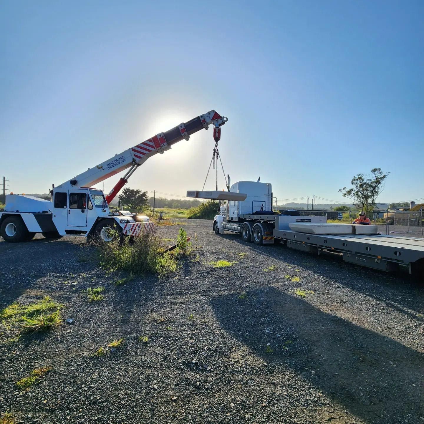 White Crane Transferring Load To A Trailer