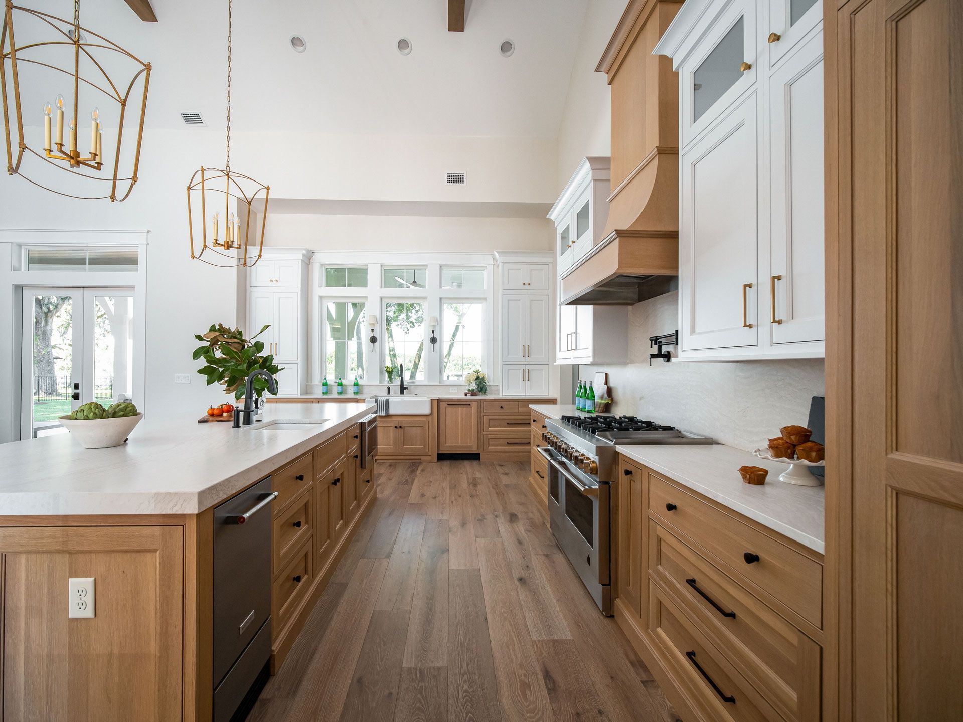 Modern kitchen with white and wood cabinetry, island, and hardwood floors.