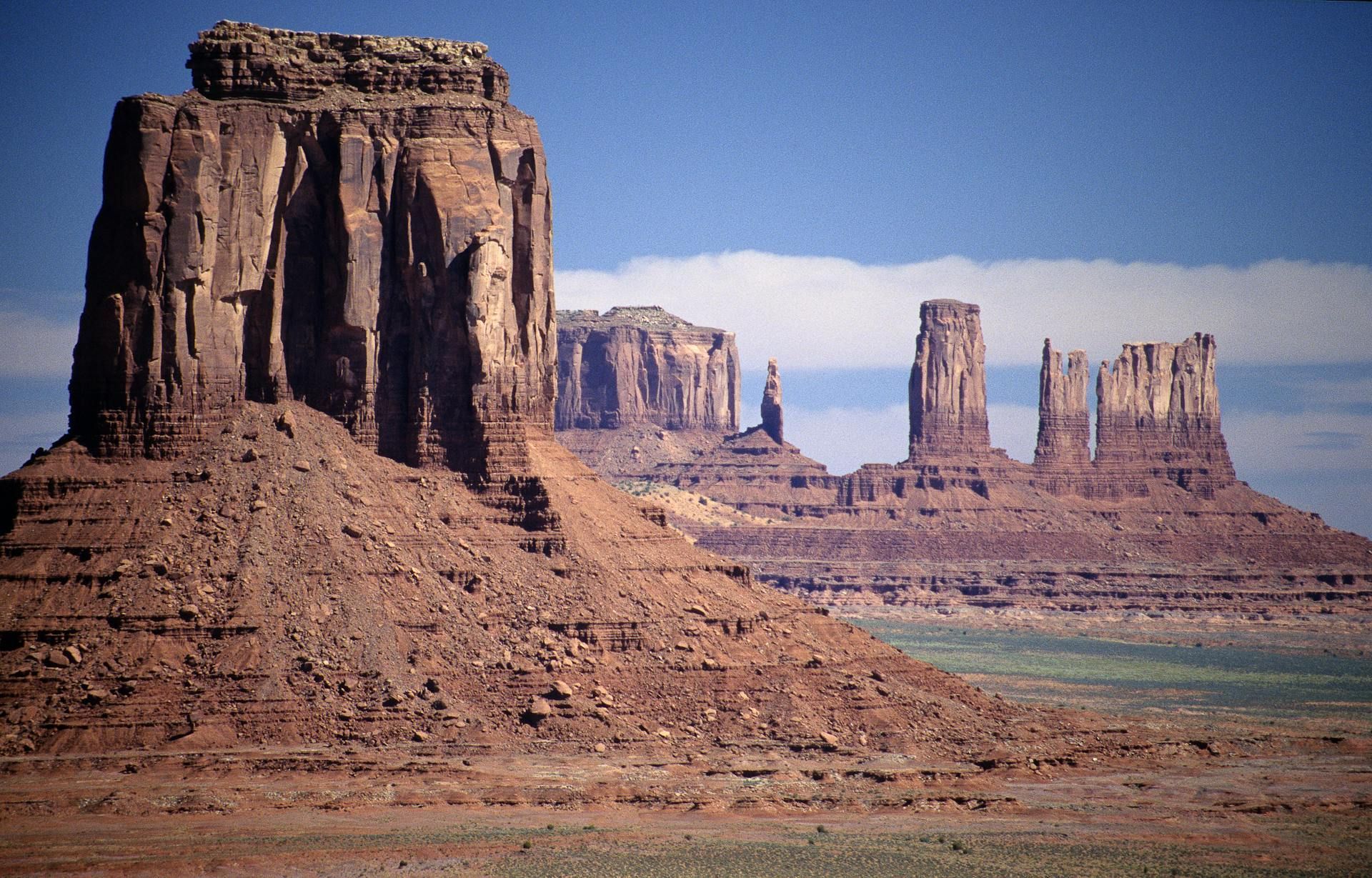Red rock formations in a desert landscape under a blue sky.