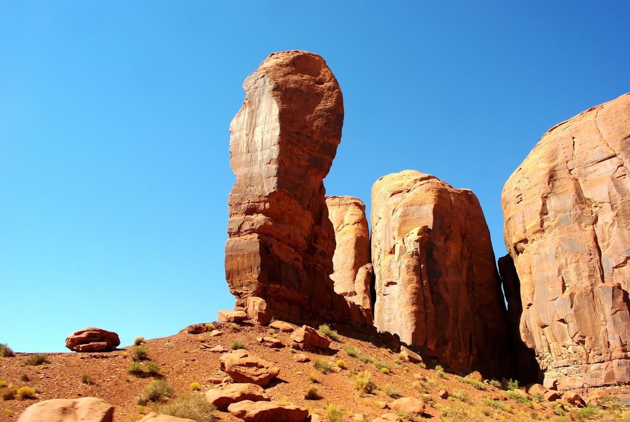 Red rock formations against a bright blue sky, Monument Valley, Utah.