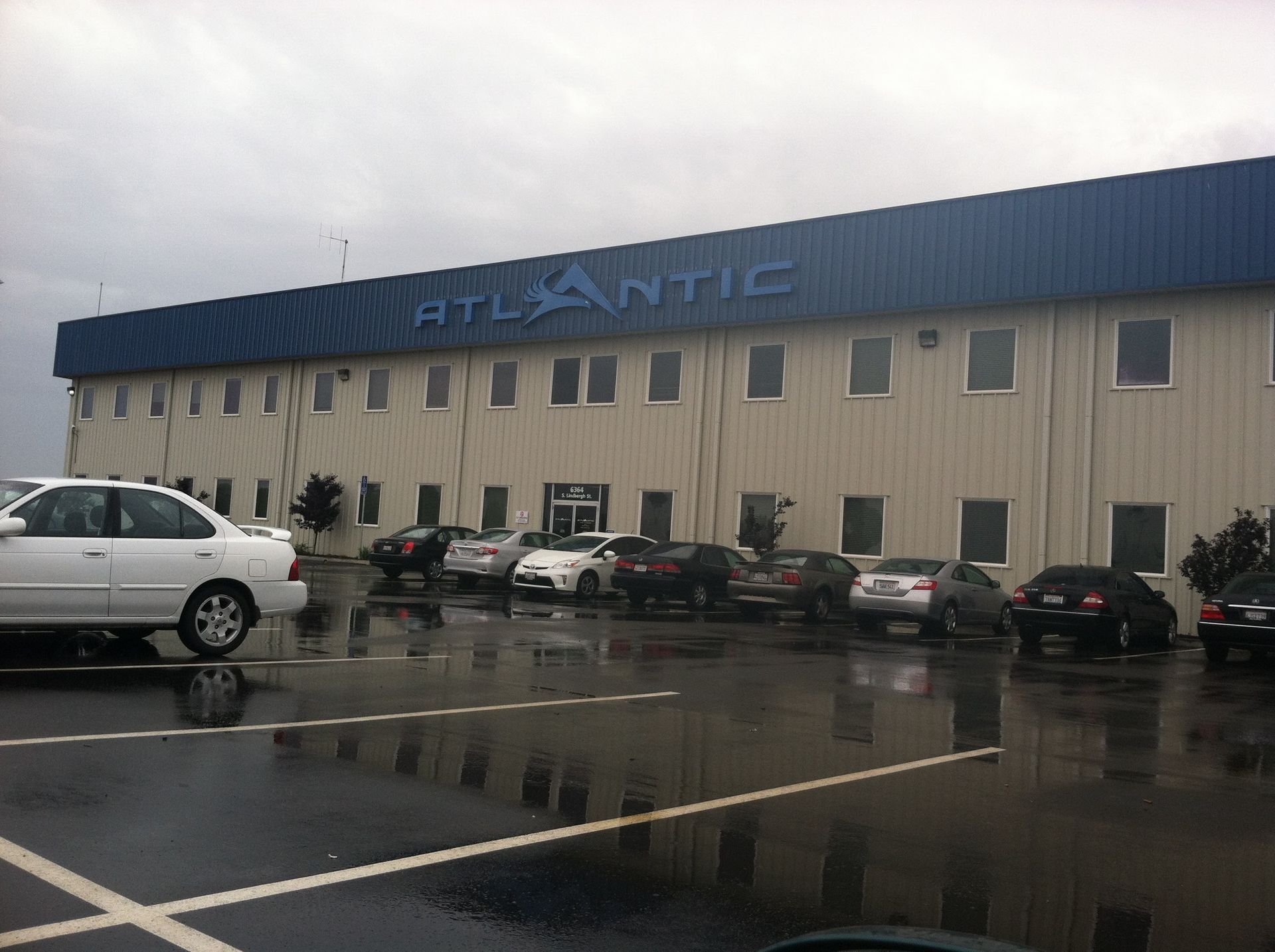 Atlantic building exterior on a cloudy day, cars parked in front.