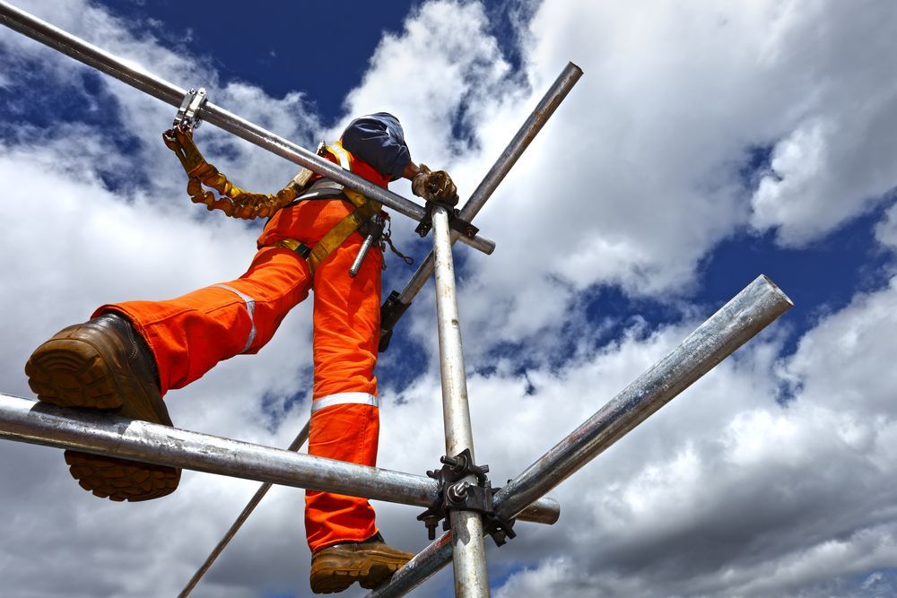 Scaffolding on a White Building Against a Partly Cloudy Blue Sky — Top Tier Scaffolding In Underwood, QLD