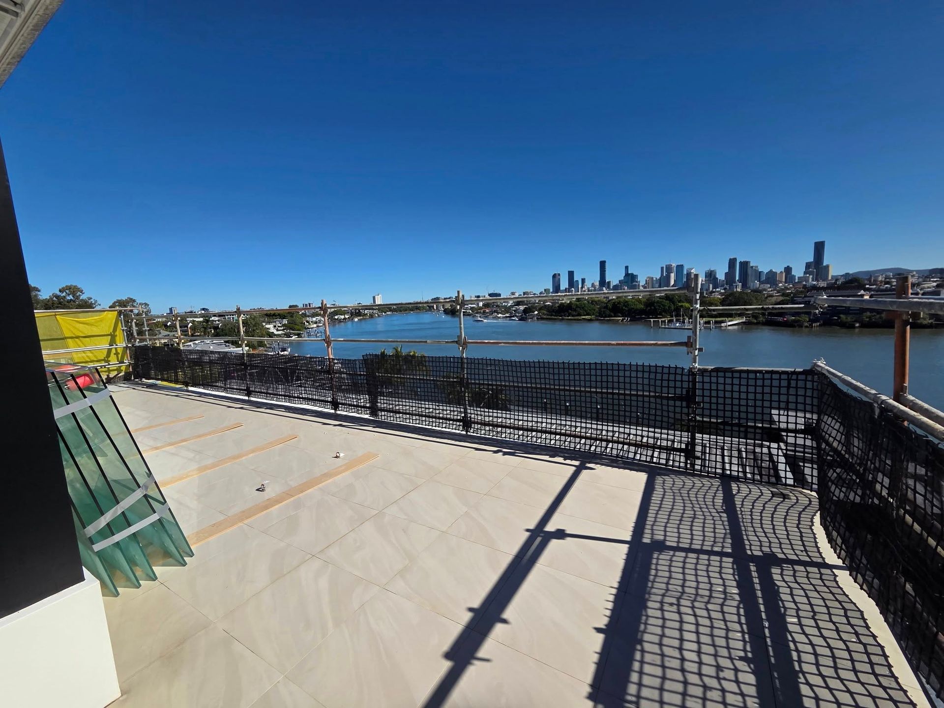 Construction Scaffolding Next to a Building, With a Stage and a Tree Nearby — Top Tier Scaffolding in Underwood, QLD