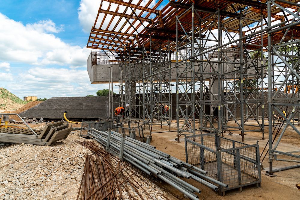 Construction Site With Metal Scaffolding Under a Partially Built Structure — Top Tier Scaffolding In North Lakes, QLD