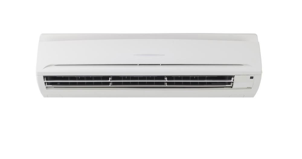 A White Air Conditioner Is Hanging On A White Wall — Jervis Bay Airconditioning In Kemblawarra, NSW