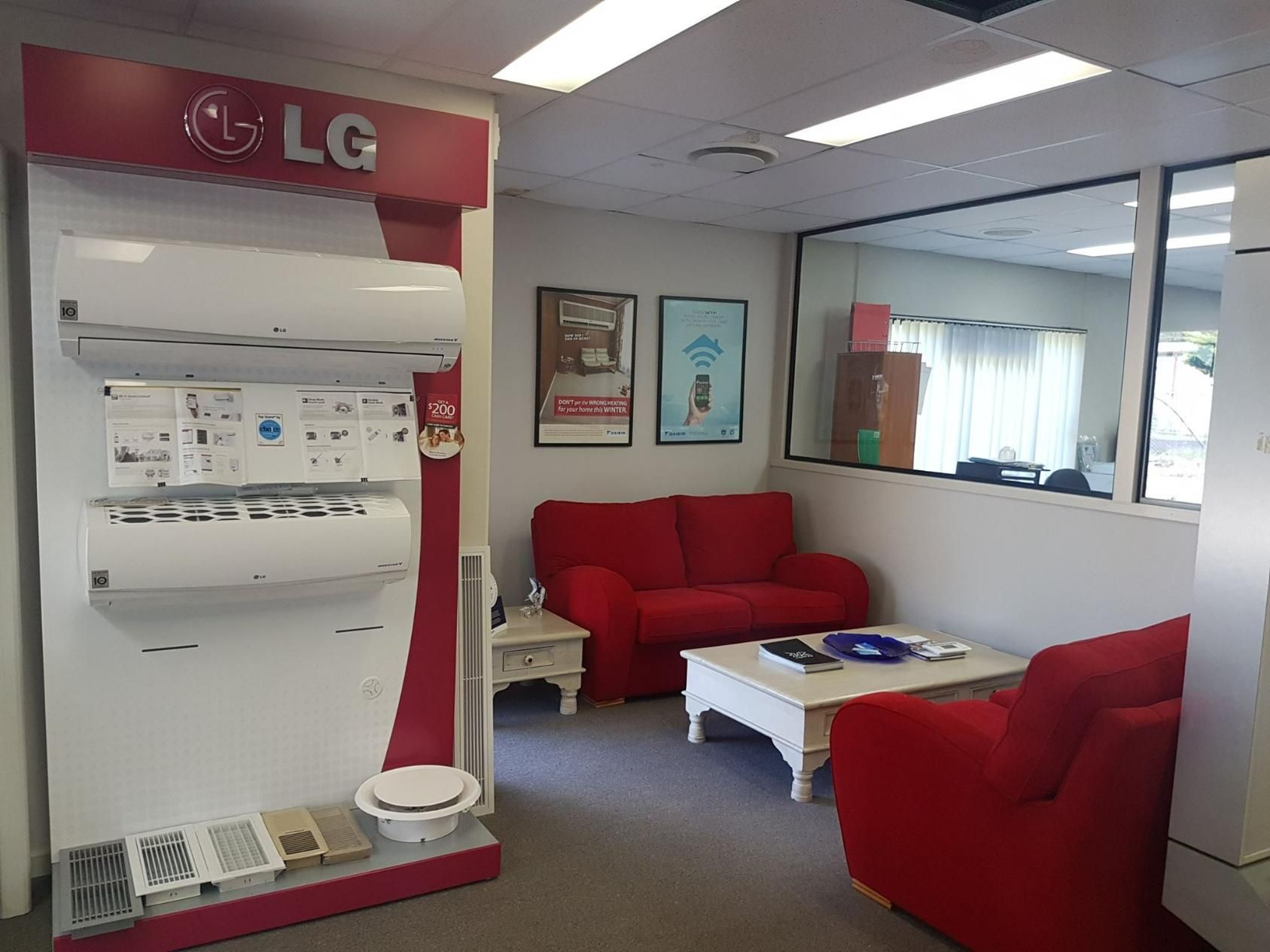 A Living Room With A Red Couch And A White Coffee Table — Jervis Bay Airconditioning In Sanctuary Point, NSW