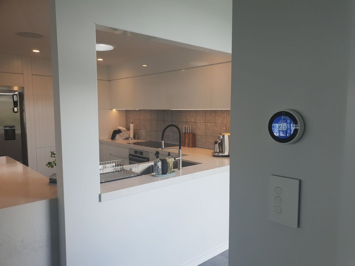 A Kitchen With A Thermostat On The Wall And A Sink — Jervis Bay Airconditioning In Huskisson, NSW