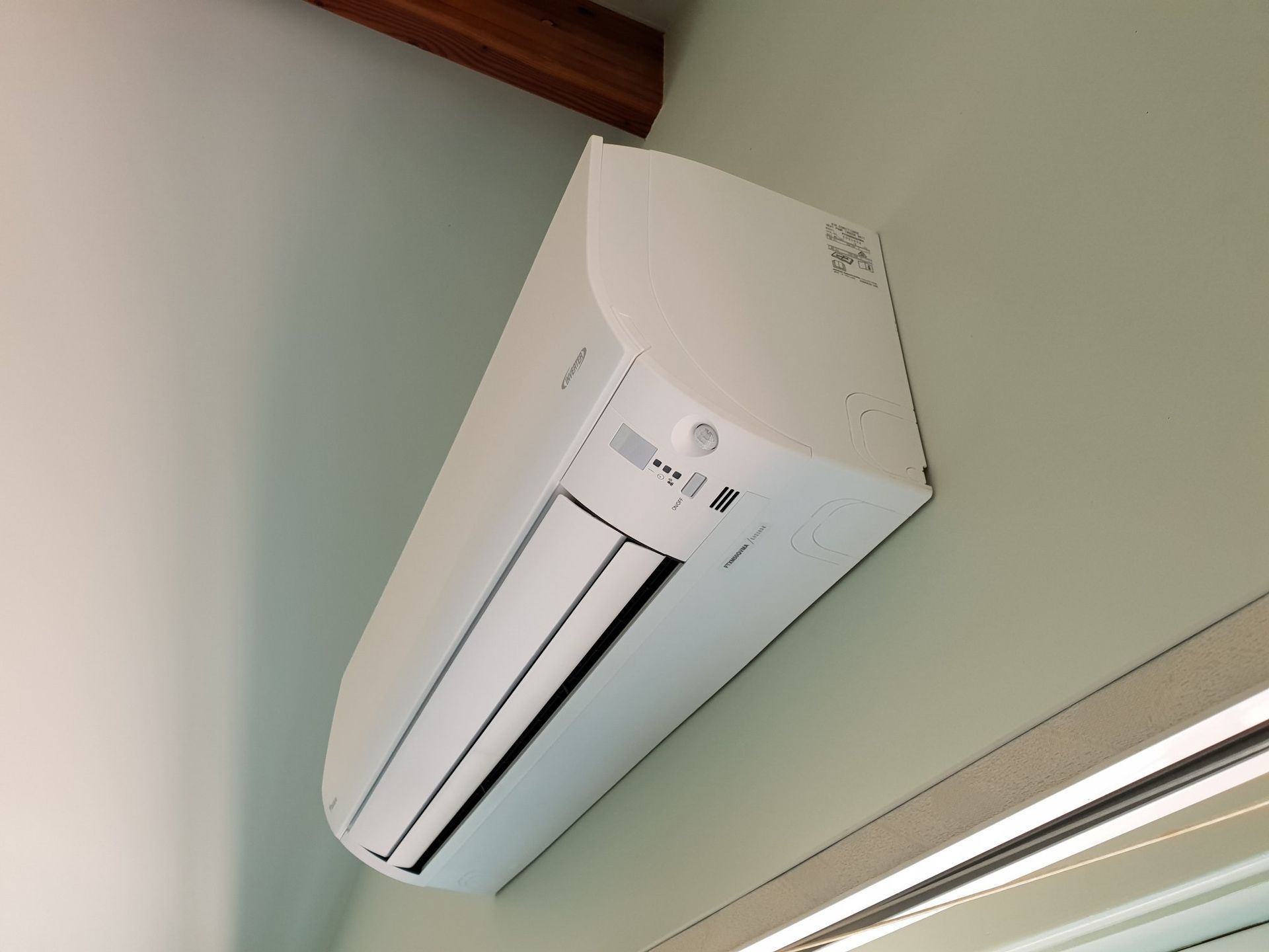 A White Air Conditioner is Hanging From the Ceiling — Jervis Bay Airconditioning In Huskisson, NSW