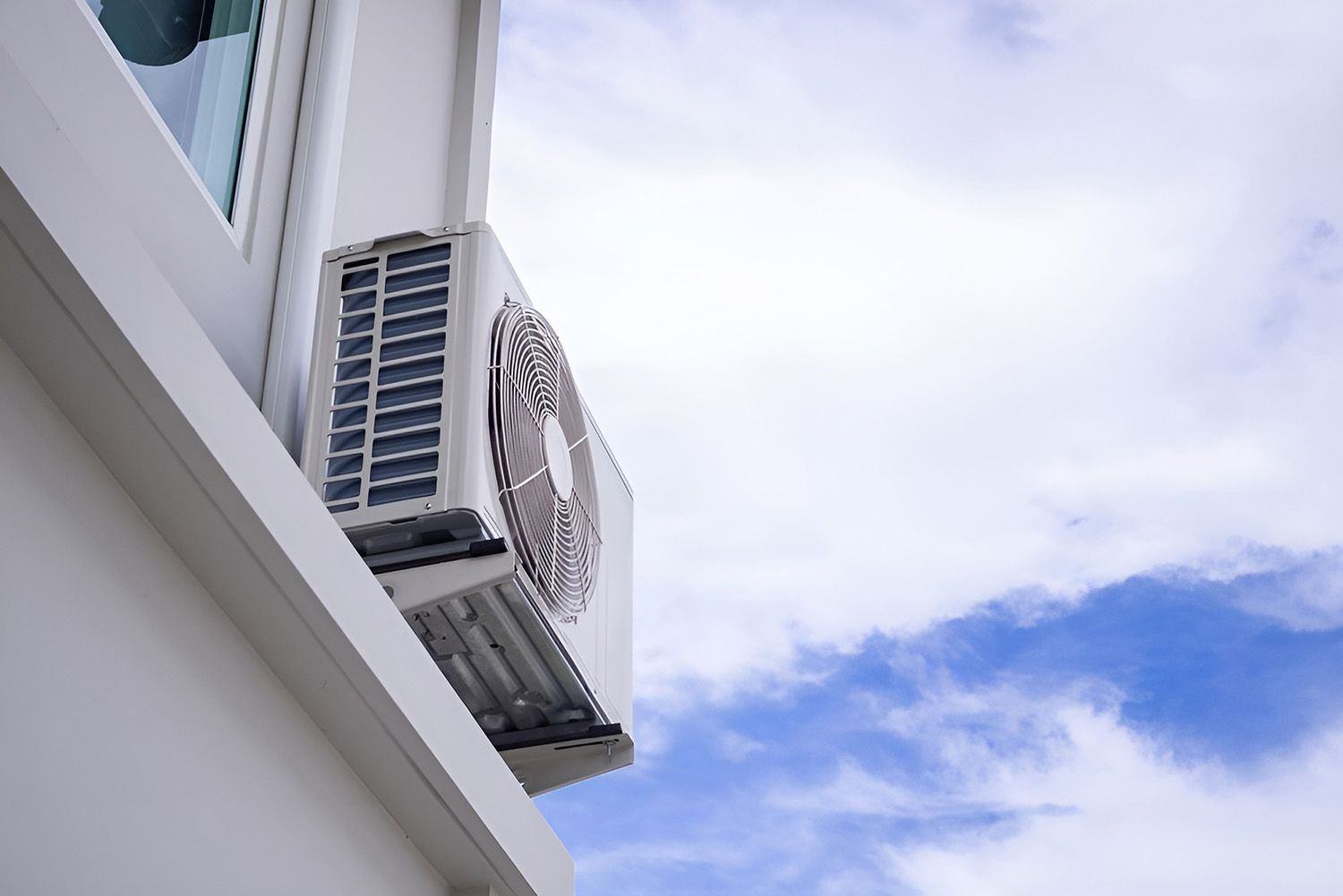 Air Conditioning Unit Mounted On A White Building Exterior