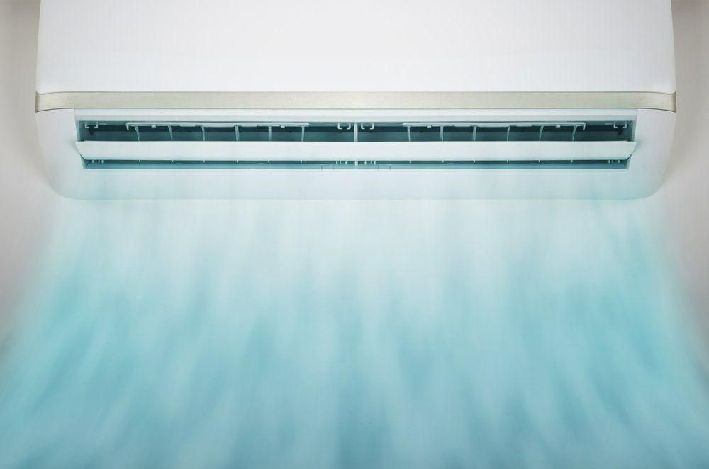 A White Air Conditioner Is Hanging On A Wall And The Air Is Coming Out Of It — Jervis Bay Airconditioning In Huskisson, NSW