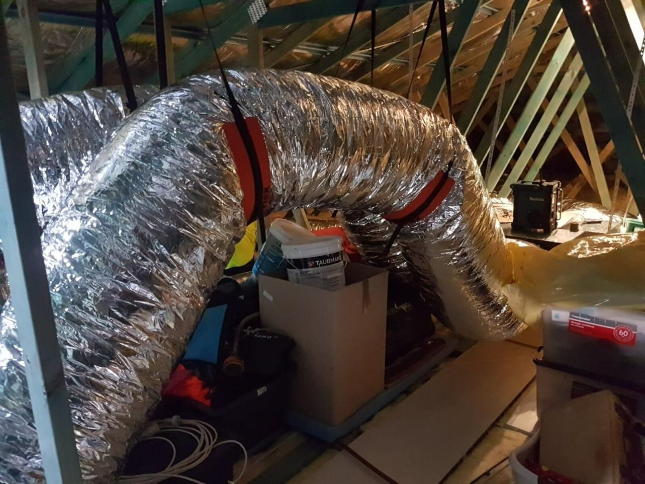 A Large Duct Is Hanging From The Ceiling Of An Attic — Jervis Bay Airconditioning In Berry, NSW