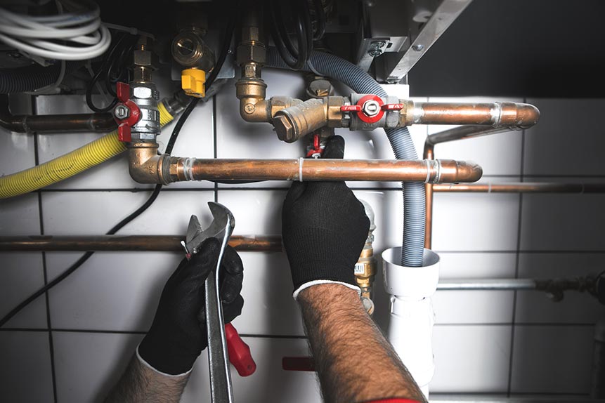 Hands Of A Man Fixing Pipes — Meridian, MS — Roto-Rooter Plumbers