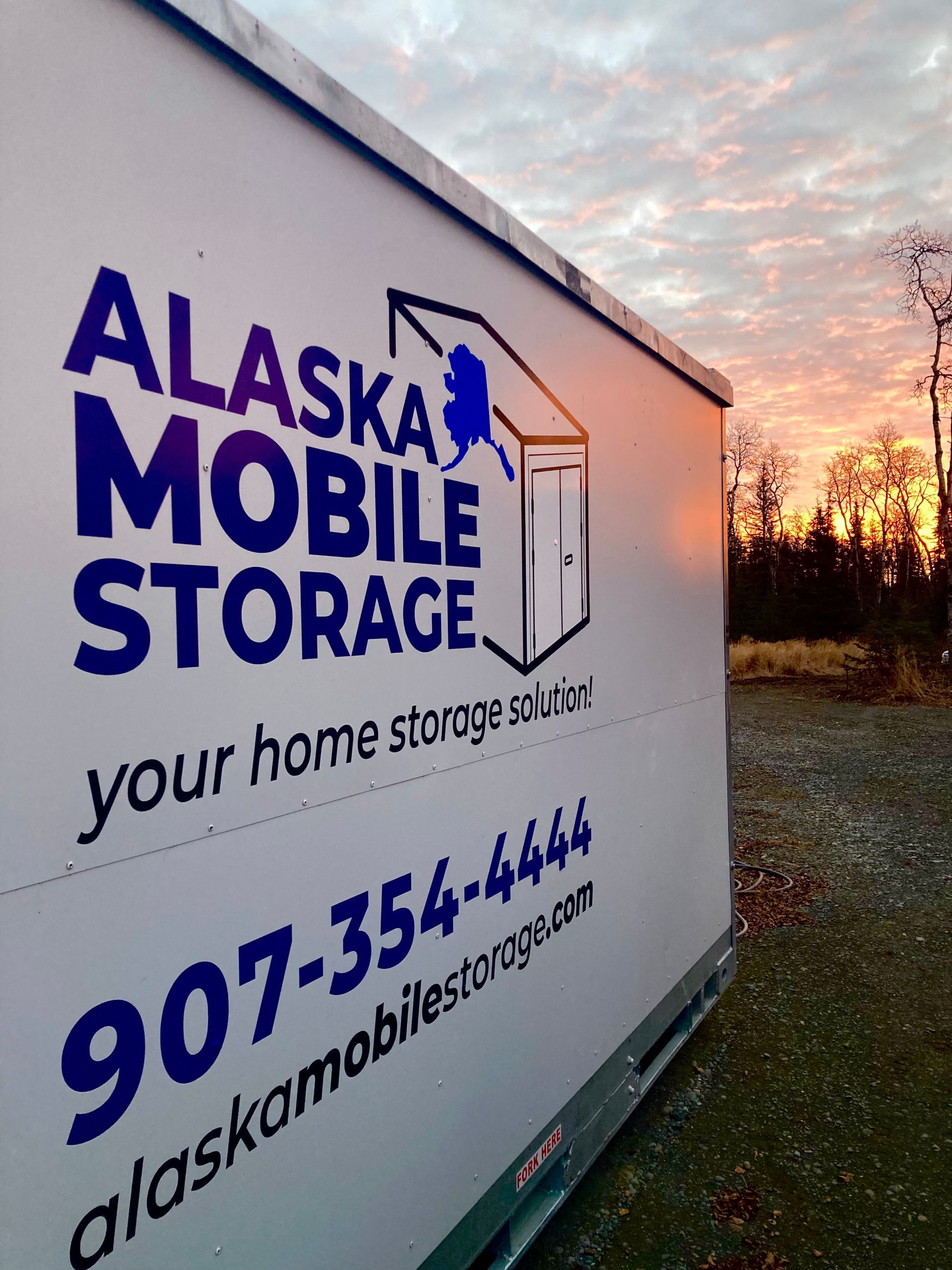 A white and blue sign for alaska mobile storage