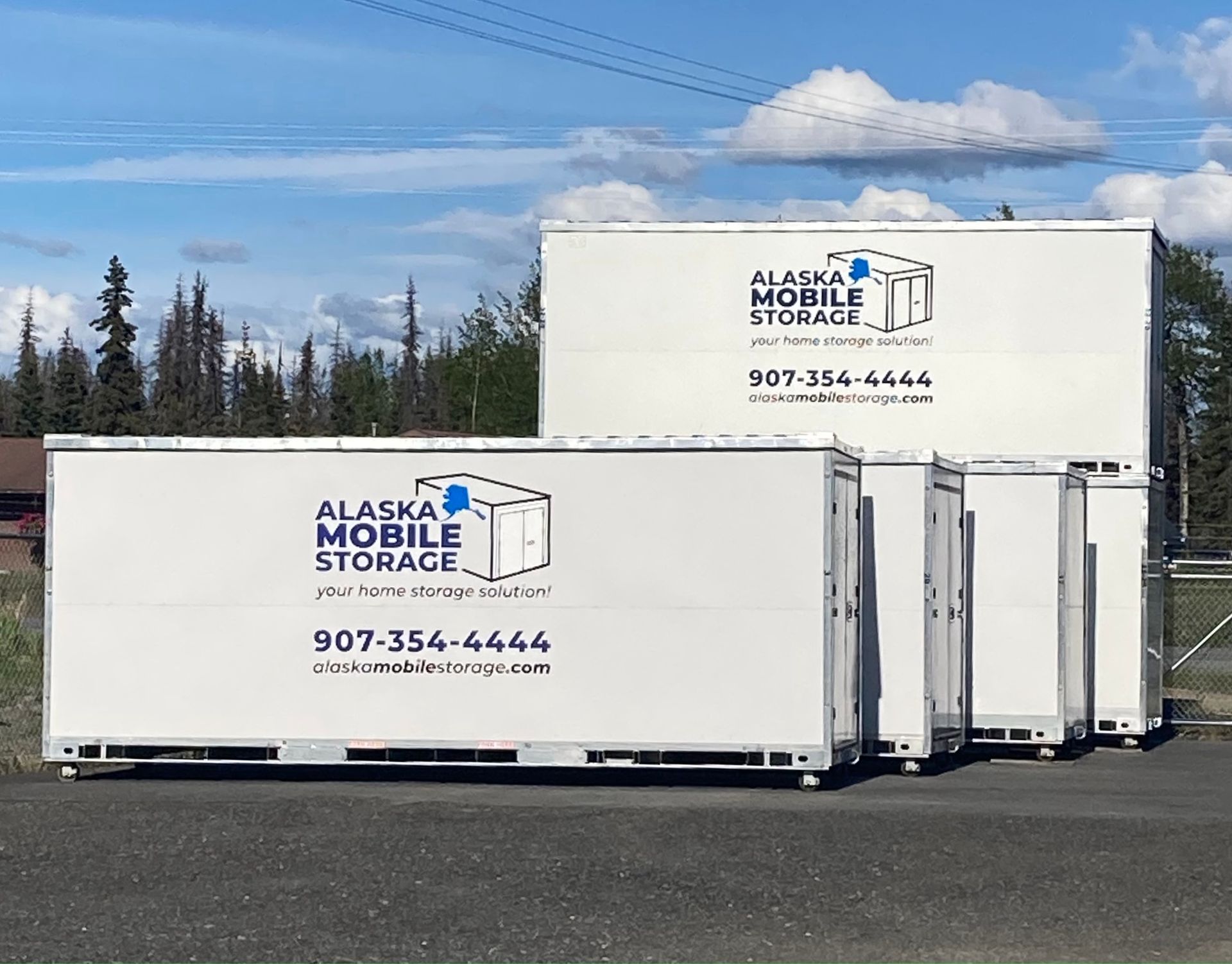 A row of alaska mobile storage containers are parked next to each other