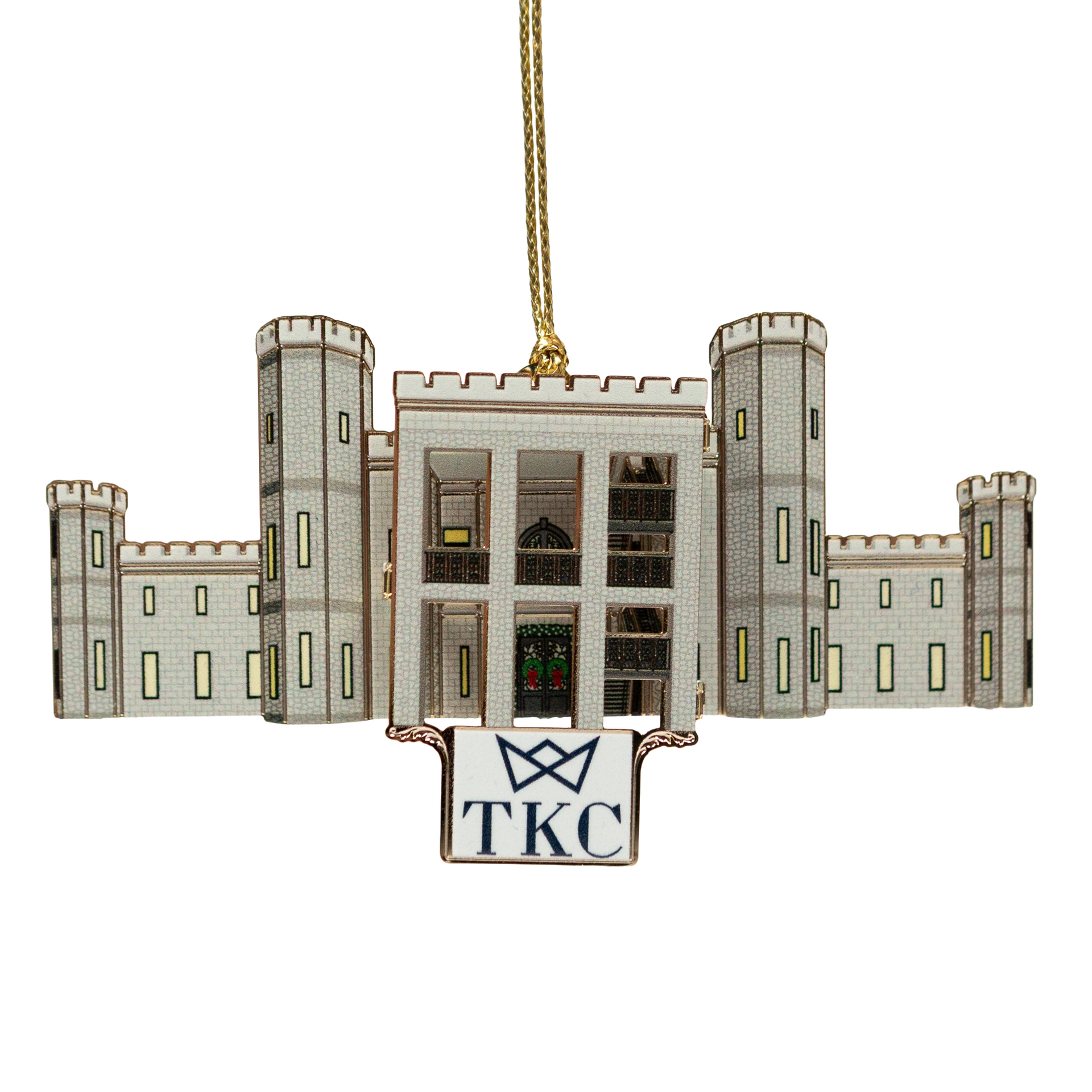 Ornament of a white building in a dark blue box with a gold hanging string.